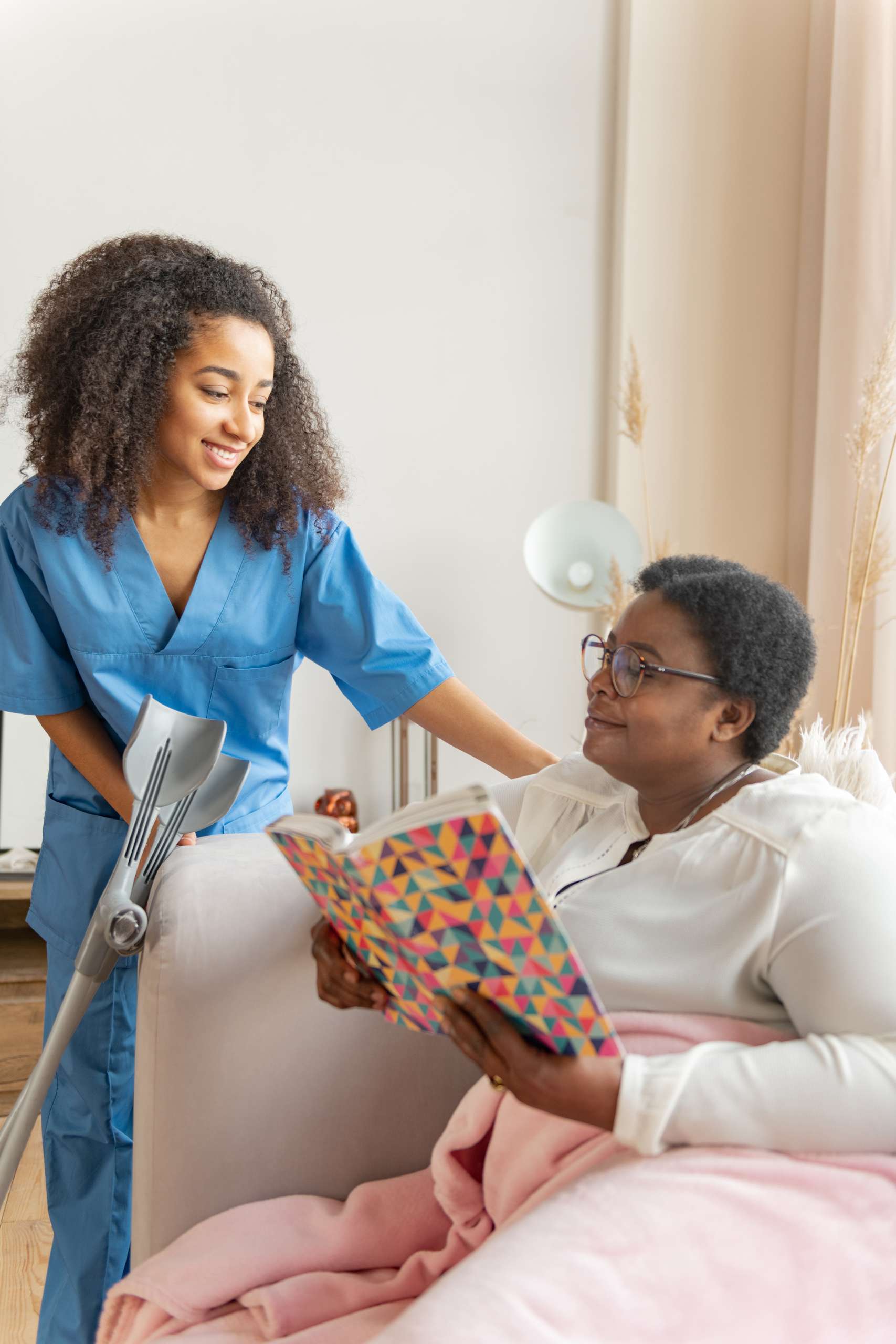 Pleasant medical attendant asking about the well-being of patient